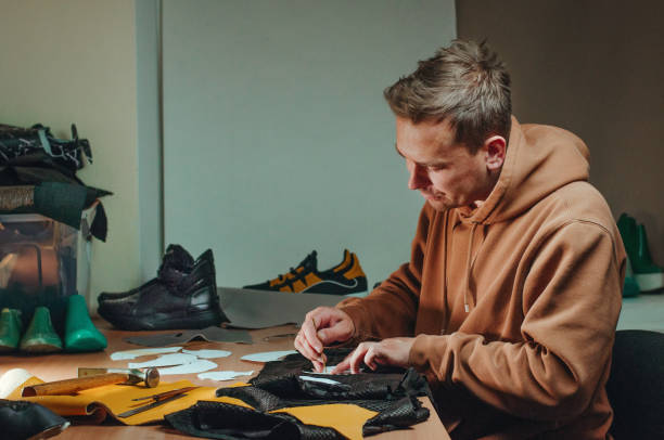 person making homemade shoes